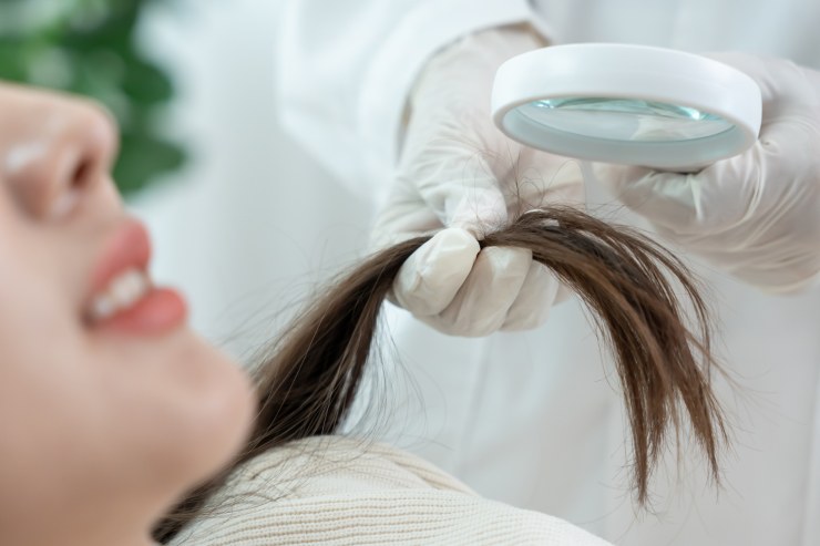 Dermatologo Tricologo che controlla lo stato dei capelli di una ragazza